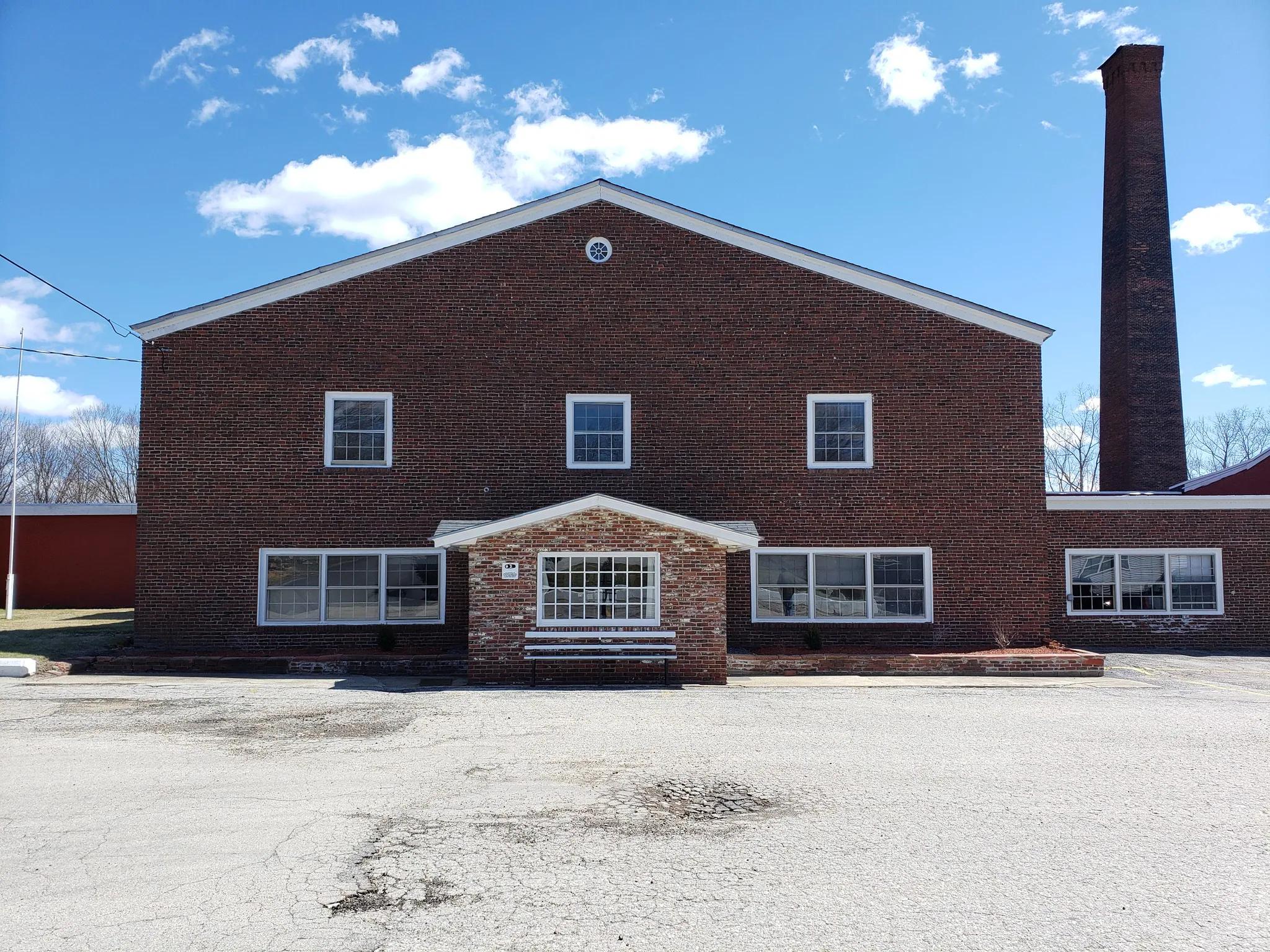 Front entrance showing professional masonry architecture and landscaping