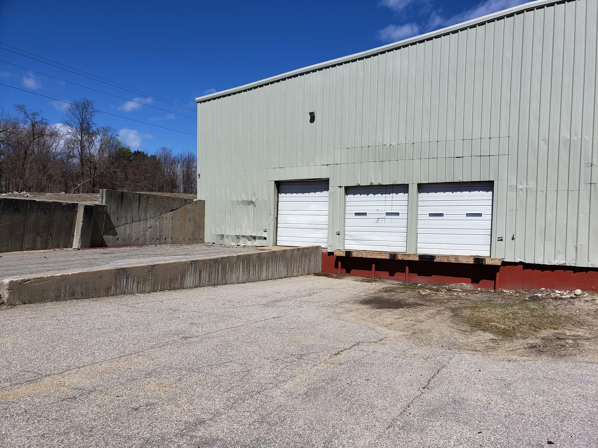 Rear exterior view showing building dock doors and drive-ins